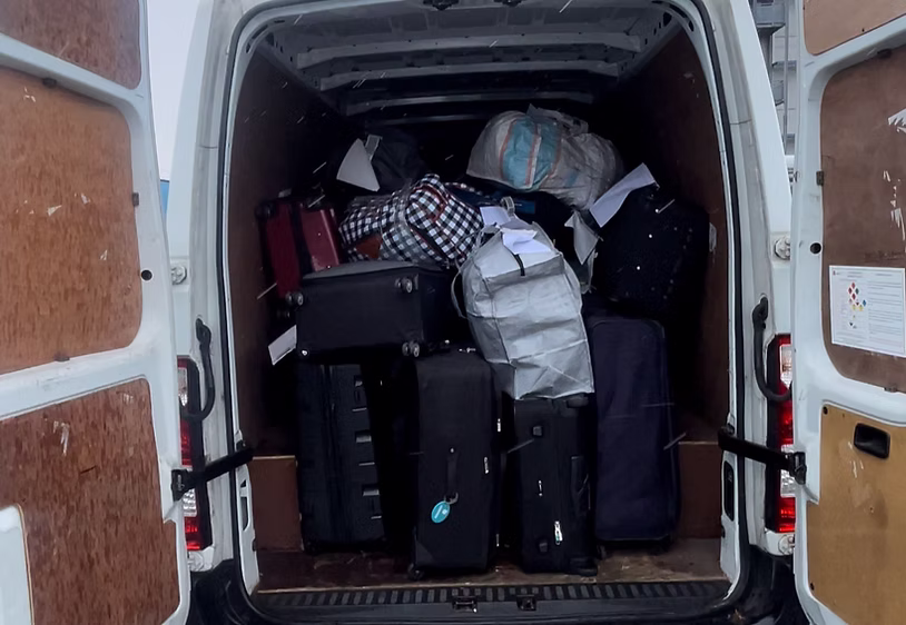 Van loaded with luggage and suitcases for airport collection